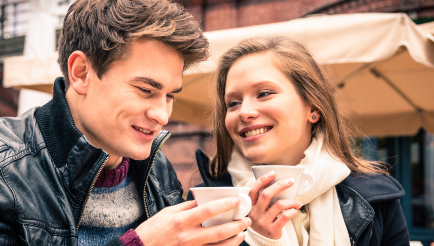 Couple dressed in jackets enjoying a warm drink